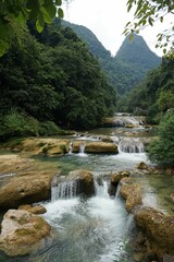 Fototapeta na wymiar Vertical shot of a waterfall in a forest in Guizhou, China perfect for wallpapers and backgrounds