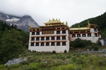 Monastery on the cloud-capped mountains in the Daocheng Yading National Park, Sichuan, China.