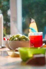 Vertical shot of a bowl with cut cucumber in selective focus