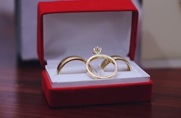 Closeup shot of gold marriage rings in a red box