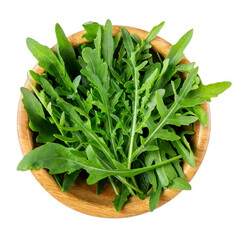 Fresh arugula (Eruca vesicaria), green rocket leaves in wooden bowl isolated on white background. Top view.