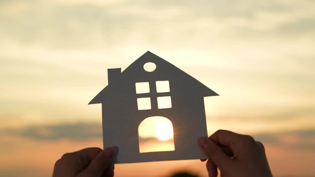 hands holding paper house, window sunset ray, happy family mortgage build new house, refinancing your mortgage, property market analysis, buying foreclosed homes, new neighborhood exploration