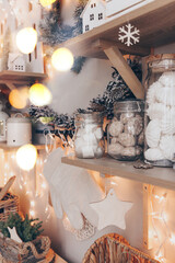 Cozy Christmas photo of candy shop decorated in style of New Year holidays, glass jars with cookies