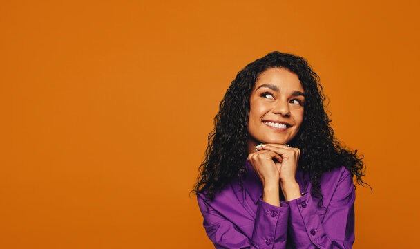 Smiling woman on colorful background with curly hair