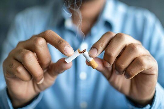 Man Breaking Cigarette to Stop Smoking for Prevention of Unhealthy Nicotine Habits