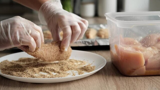 Cooking chicken fillet in breadcrumbs, stock footage video 4k