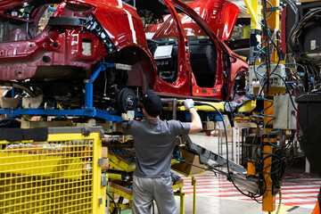 Industrial production of car automobiles. Plant for assembling modern cars on an assembly line....