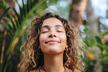 Fototapeta premium A happy young woman breathing fresh air outdoors