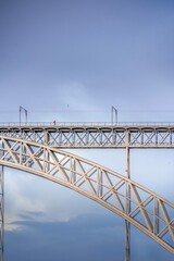 Fototapeta na wymiar Frontal view from the river of the steel bridge Don Luis I. Douro river in Porto. Lisbon.