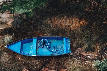 An old blue boat on the banks of the Douro River in Porto, Portugal.