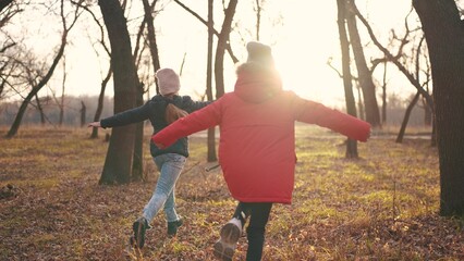 children run in the forest in autumn park. happy family kid dream concept. a group of children in...