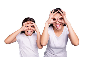 Close up photo beautiful two people brown haired mom little daughter best friends look through finger glasses specs okey symbol tongue out mouth wearing white t-shirts isolated bright blue background