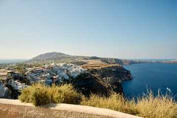 Panoramic view of Thira (Fira), the capital city of Santorini, greek village situated on the cliff, Santorini Island, Cyclades, Greece - obrazy, fototapety, plakaty