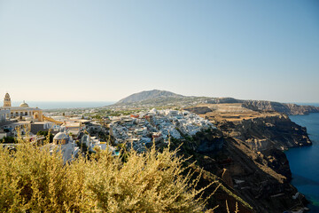 Panoramic view of Thira (Fira), the capital city of Santorini, greek village situated on the cliff,...