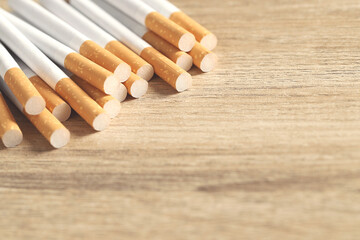 image of several commercially made cigarettes. pile cigarette on wooden. or Non smoking campaign...