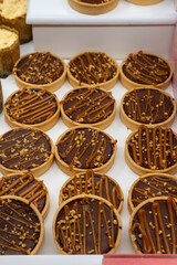 Creative and appetizing chocolate sweet dessert in the window of a pastry shop along with other delicious sweets.
