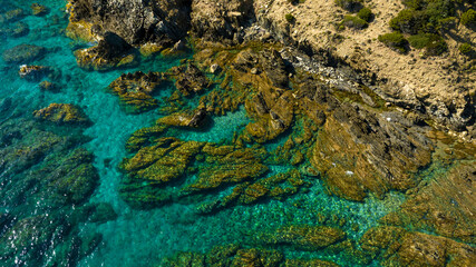 Aerial view on the rocks in the crystal clear sea of southern Sardinia, Italy. The sea is clean...