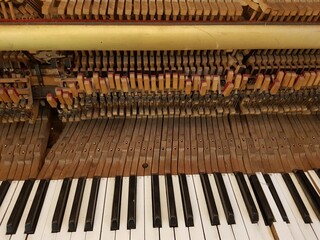 Vintage traditional upright piano keys and mechanism close up