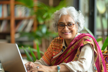 Indian senior working on laptop at library