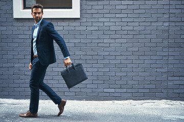 Man, walking and brick wall in city for business with briefcase, work commute, and corporate...
