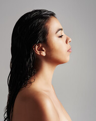 Woman, profile and beauty salon with haircare, cosmetics or shower on a gray studio background....
