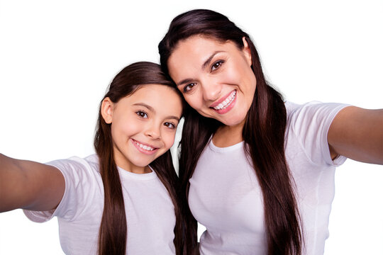 Close up photo two people brown haired mum mom small little daughter make take selfies for daddy wait him his he home house missing wear white t-shirts isolated bright blue background