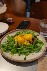 slow cooked pork ham with arugula salad and two poached egg