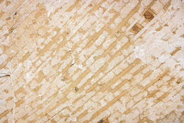Old peeling beige textured wall.