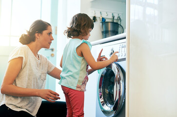 Help, home and mom with girl at washing machine for chores, teaching and learning housekeeping...