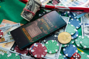 Poker new cards with various chips and money are laid out on a green playing poker table. Poker concept. Game concept