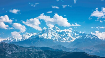 Majestic mountain landscape with snow peaks under blue sky