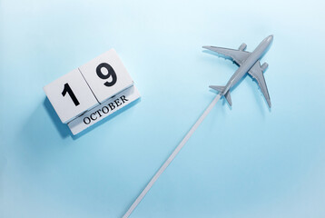 October calendar with number  19. Top view of a calendar with a flying passenger plane. Scheduler....