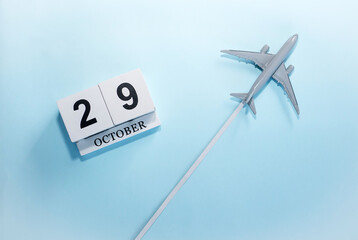October calendar with number  29. Top view of a calendar with a flying passenger plane. Scheduler....