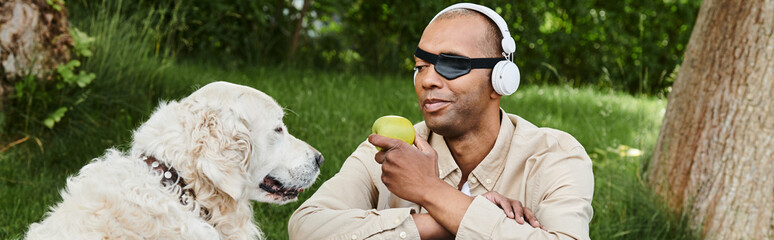A disabled African American man with myasthenia gravis syndrome listens to headphones while eating...