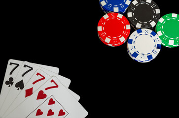 Obraz premium Poker chips and cards in a casino on a black background