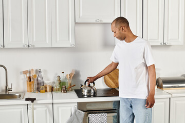 A disabled African American man with myasthenia gravis syndrome stands in a kitchen near stove