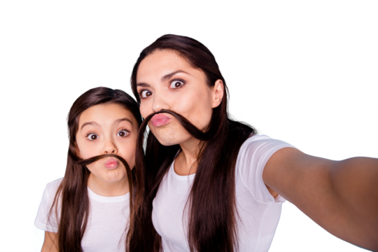 Close up photo amazing beautiful two people brown haired mom small little daughter make take selfies make moustache with curls pretend guy man male wear white t-shirts isolated bright blue background