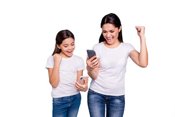 Obraz premium Close up photo beautiful two people brown haired mom small little daughter hold telephone reader great news fists in air win free sale discount wear white t-shirts isolated bright blue background