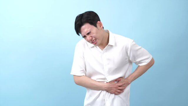 Young Asian man on blue background