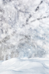 Snowdrifts in the forest. Winter landscape. Falling snow on a blurred background of trees. Beauty...