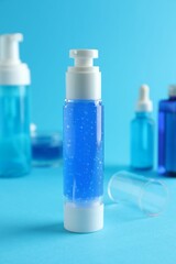 Different cosmetic products on light blue background