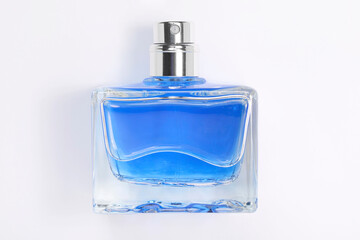 Blue men's perfume in bottle on white background, top view