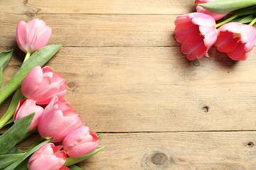 Happy Mother's Day. Beautiful pink tulips on wooden table, flat lay. Space for text