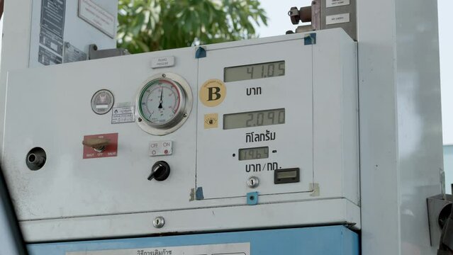 Numbers for amount of liters and price equivalent in Baht are displayed on a gauge machine at a refuelling station in Bangkok, Thailand.