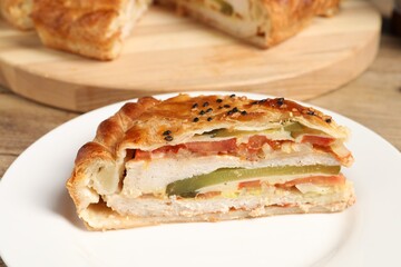 Piece of tasty homemade pie with filling on wooden table