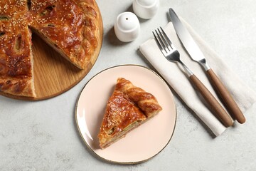 Tasty homemade pie served on light grey table, flat lay