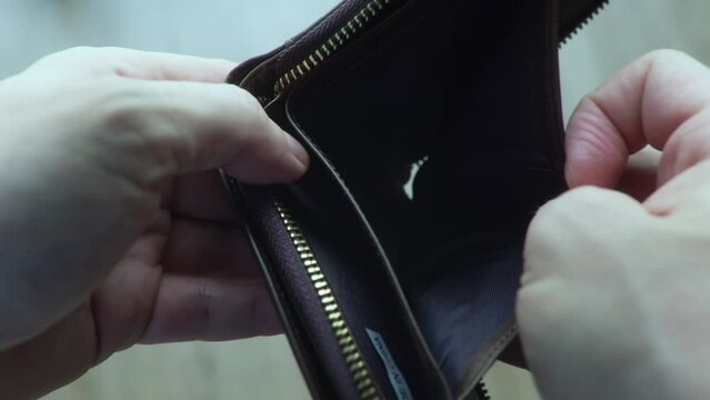 Economic crisis and troubles at work, no saving cash, global unemployment. Close up man hands opening an empty wallet. Financial crisis and despair. No money, poverty concept. 4K