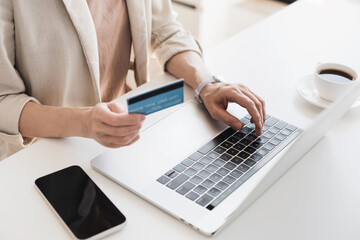 Woman using laptop computer with credit card making online order. Business, online shopping, e-commerce, internet banking, spending money, working from home concept