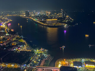 Cityscape of scenic Phnom Penh at night with the Mekong and Tonle Sap rivers and boats in Cambodia