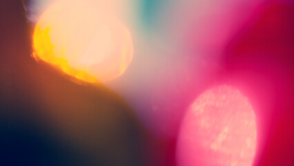 Abstract blurry background, pink, yellow, dark, light spots.